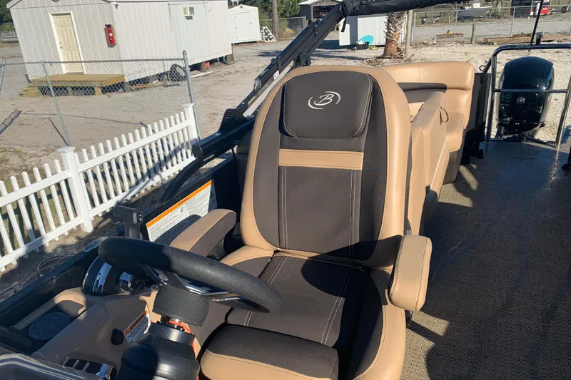 Slide: The Image of 2025 Barletta Cabrio 22QC boat interior with steering wheel and captain's chair. - 12