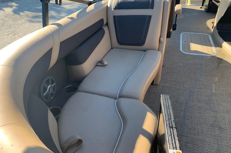 Slide: The Image of 2025 Barletta Cabrio 22QC boat interior with beige seating and cup holders. - 16