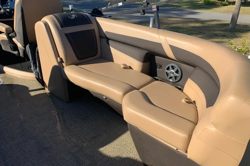 Slide: The Image of Luxurious seating on 2025 Barletta Cabrio 22QC pontoon boat, featuring tan upholstery and speaker system. - 17