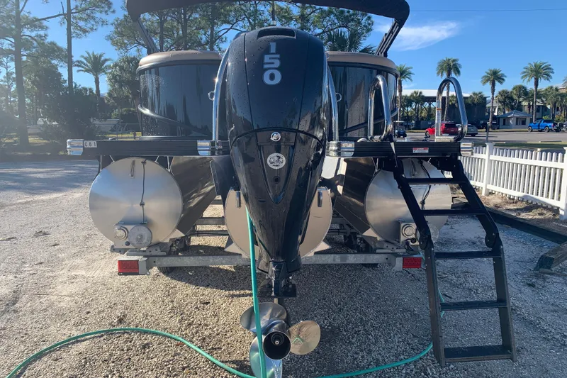 Slide: The Image of 2025 Barletta Cabrio 22QC pontoon boat with 150 HP engine, parked outdoors. - 20