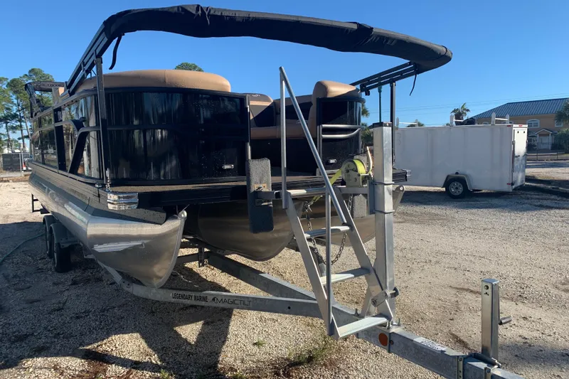 Slide: The Image of 2025 Barletta Cabrio 22QC pontoon boat on trailer, parked outdoors. - 24