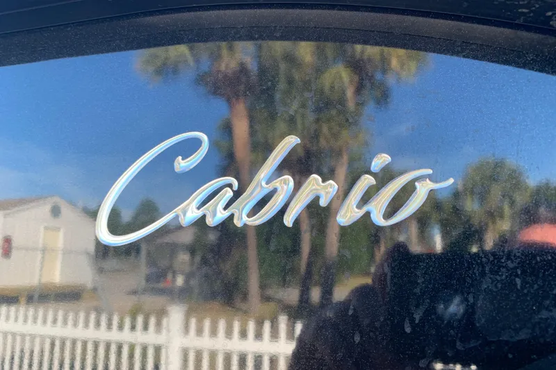 Slide: The Image of 2025 Barletta Cabrio 22QC logo with reflective surface and outdoor background. - 26