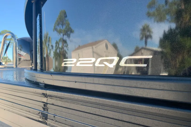 Slide: The Image of 2025 Barletta Cabrio 22QC boat exterior with reflective surface and logo. - 28
