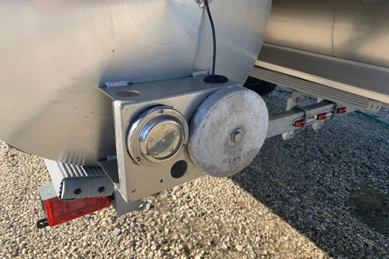 Slide: The Image of Close-up of Barletta Cabrio 22QC 2025 pontoon boat trailer hitch and light. - 30