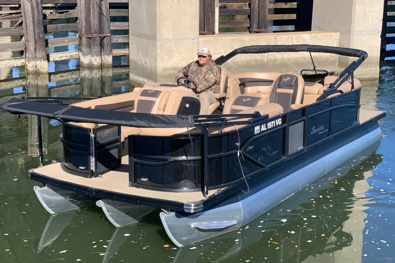 The Image of 2025 Barletta Cabrio 22QC pontoon boat on water, featuring sleek design and comfortable seating. - 4
