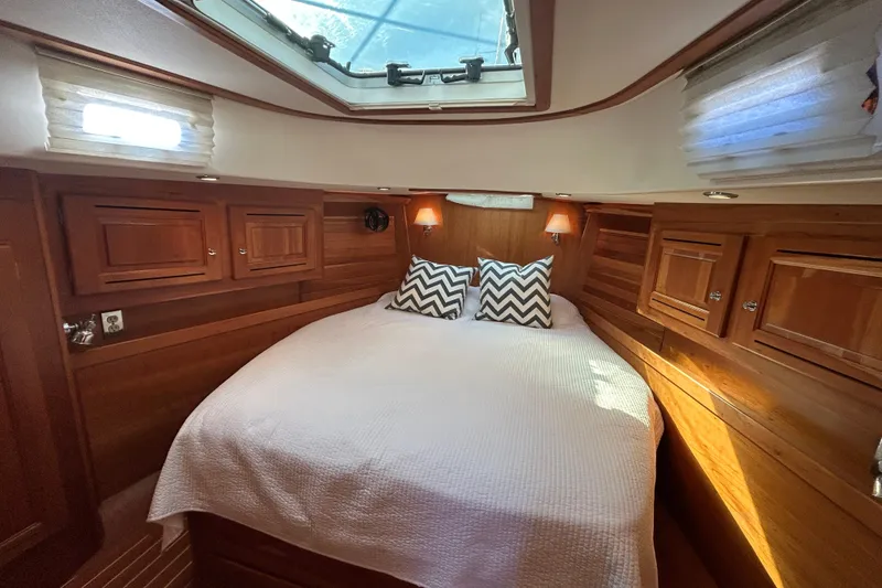 Slide: The Image of Luxurious 2003 Tartan 4400 LS yacht cabin with cozy bed and elegant wood finish. - 23