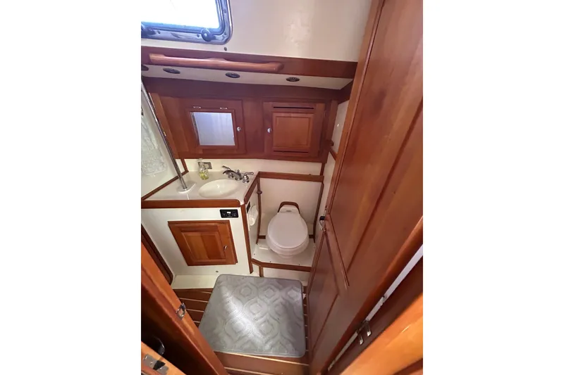 Slide: The Image of 2003 Tartan 4400 LS yacht bathroom with wooden cabinetry and compact design. - 29