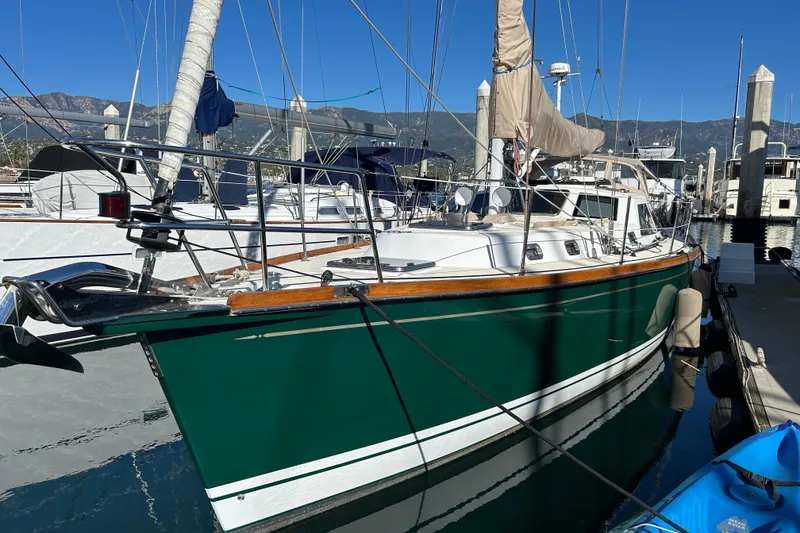 Slide: The Image of 2003 Tartan 4400 LS sailboat docked at marina with clear blue sky. - 50