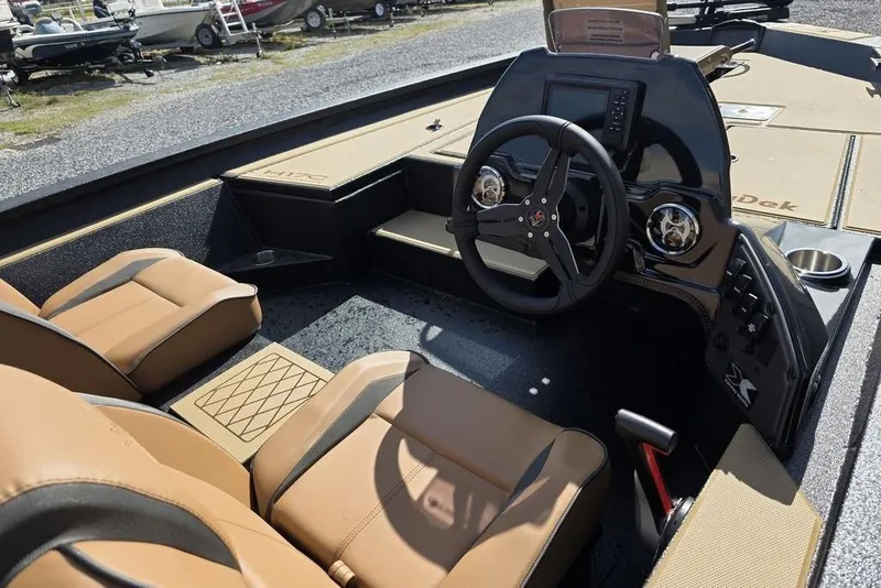 Slide: The Image of 2026 Xpress H17C Crappie boat interior with tan seats and modern dashboard. - 10