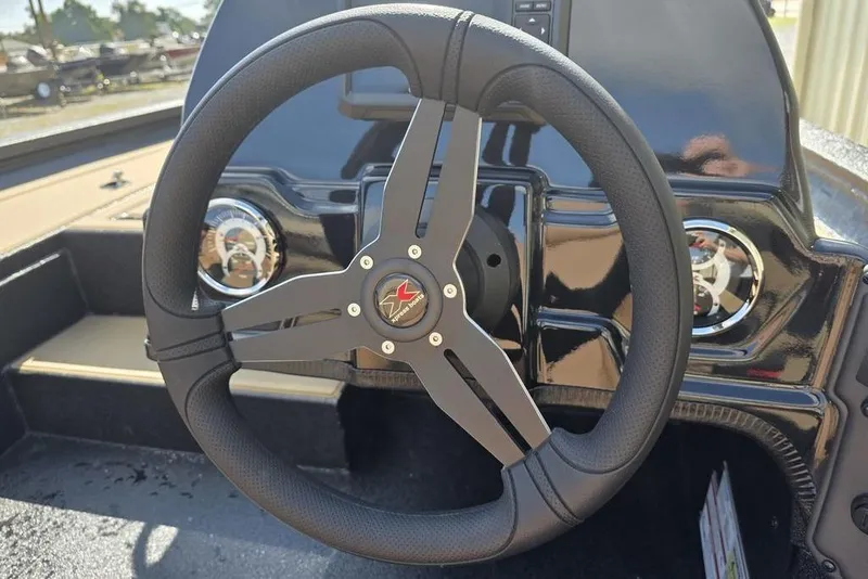 Slide: The Image of 2026 Xpress H17C Crappie boat steering wheel and dashboard close-up. - 11