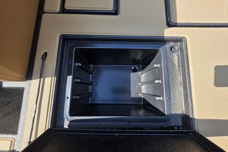 Slide: The Image of 2026 Xpress H17C Crappie boat storage compartment, open and empty. - 17