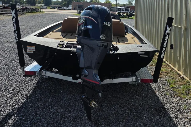 Slide: The Image of 2026 Xpress H17C Crappie boat with Yamaha 90 engine, parked on gravel. - 22