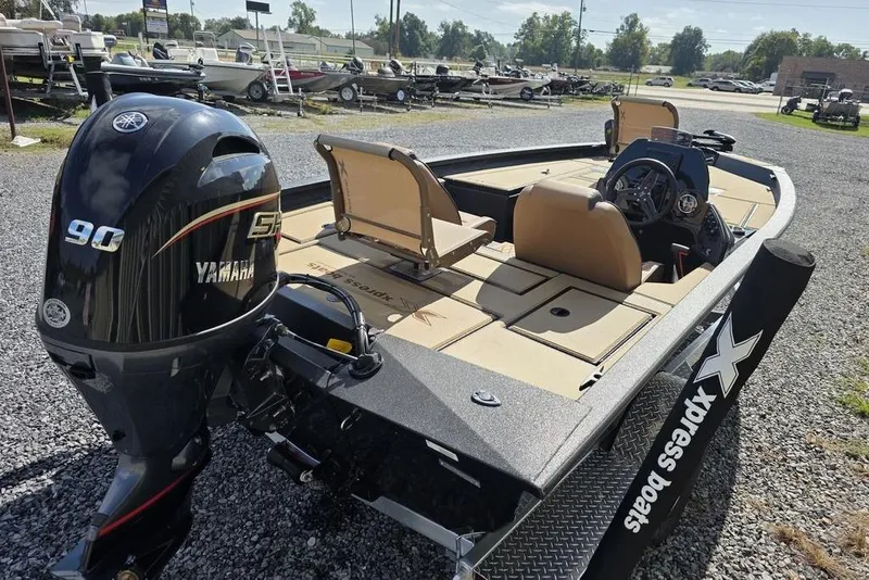 Slide: The Image of 2026 Xpress H17C Crappie boat with Yamaha 90 engine, parked on gravel lot. - 8