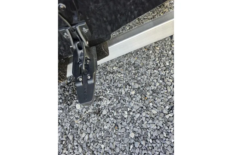 Slide: The Image of Close-up of Garmin transducer on 2026 Xpress H17C Crappie boat, resting on gravel. - 9