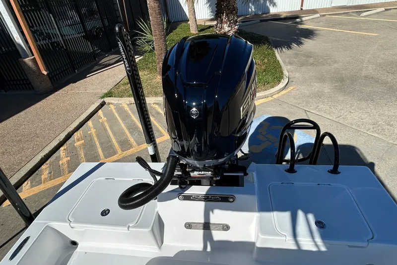 Slide: The Image of 2026 Shallow Sport 22 Sport boat with powerful engine, docked in a sunny parking area. - 10