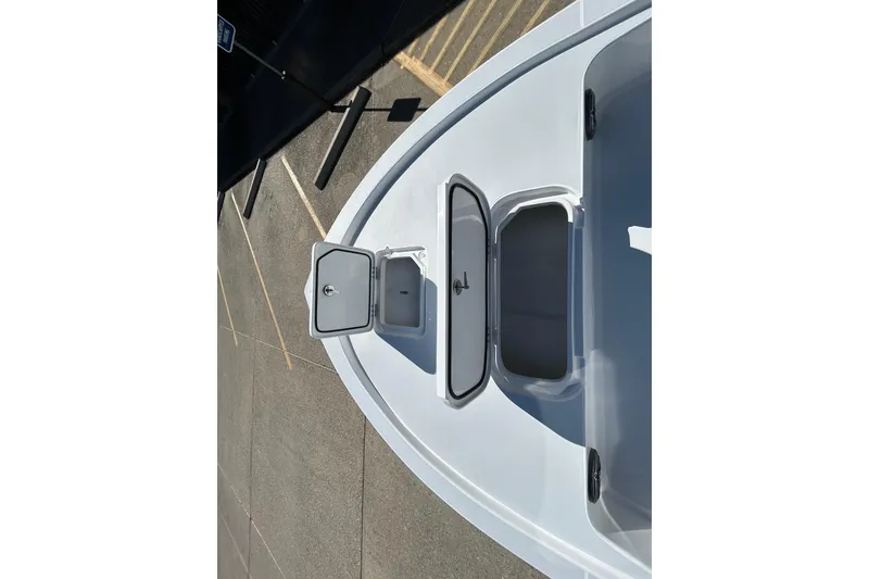 Slide: The Image of 2026 Shallow Sport 22 Sport boat deck with open storage compartments. - 17