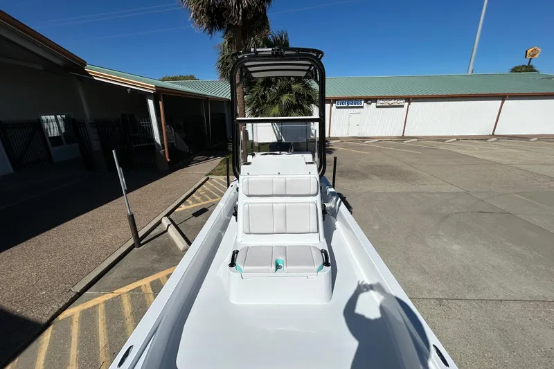 Slide: The Image of 2026 Shallow Sport 22 Sport boat in a parking lot, showcasing sleek design and seating. - 18
