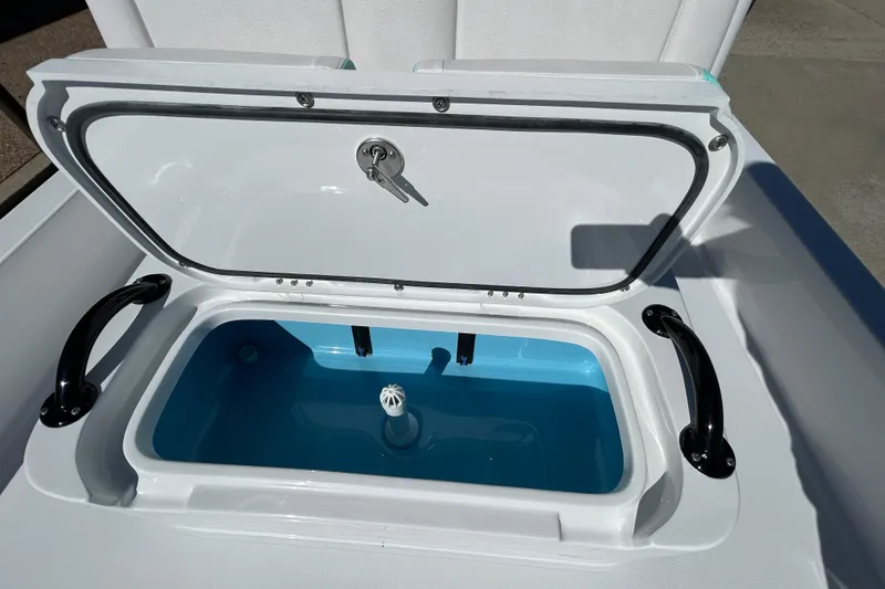 Slide: The Image of 2026 Shallow Sport 22 Sport boat livewell with open lid and blue interior. - 19