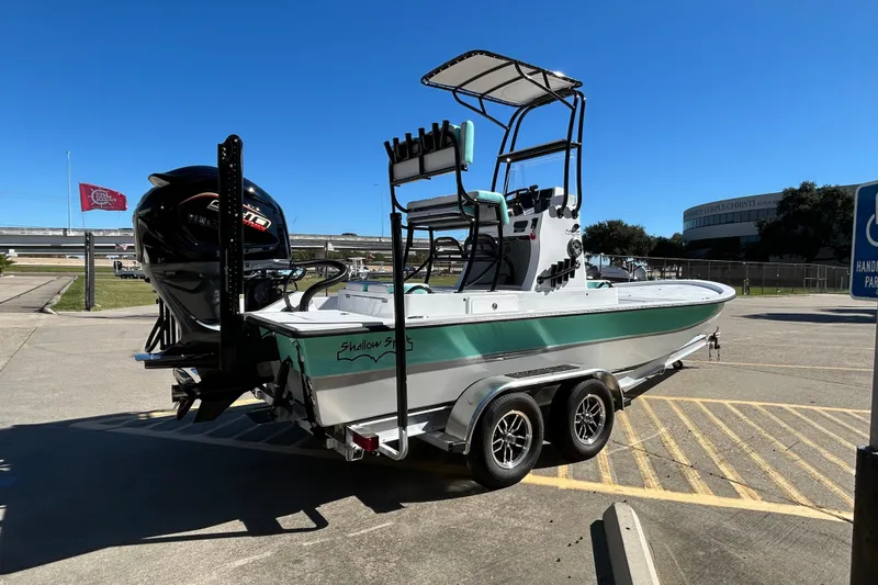 Slide: The Image of 2026 Shallow Sport 22 Sport boat on trailer in parking lot, sunny day. - 6