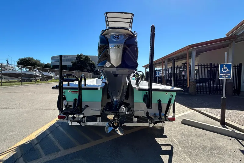 Slide: The Image of 2026 Shallow Sport 22 Sport boat with powerful outboard motor in a parking lot. - 7