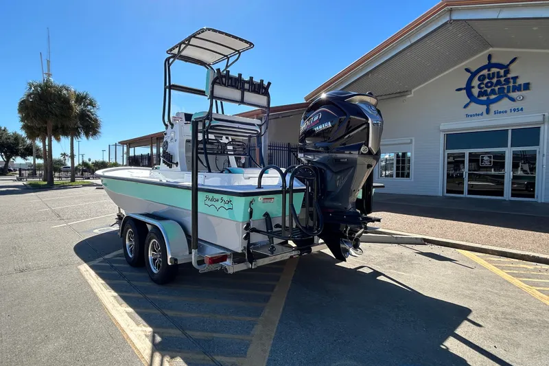 Slide: The Image of 2026 Shallow Sport 22 Sport boat on trailer outside Gulf Coast Marine dealership. - 8