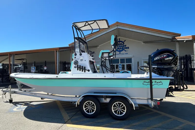 Slide: The Image of 2026 Shallow Sport 22 Sport boat on trailer outside Gulf Coast Marine. - 9