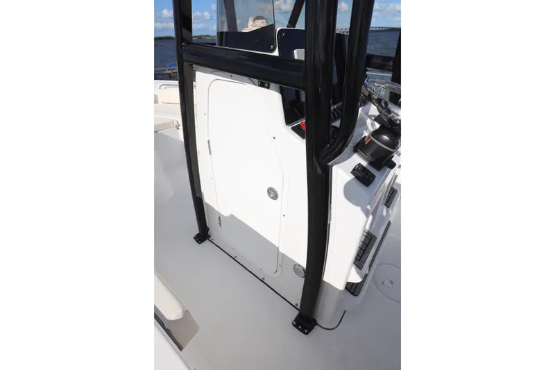 Slide: The Image of 2026 Sea Hunt Ultra 229 boat console with black frame and white door. - 10
