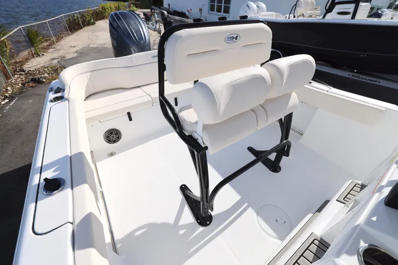 Slide: The Image of 2026 Sea Hunt Ultra 229 boat interior with white seating and sleek design. - 12