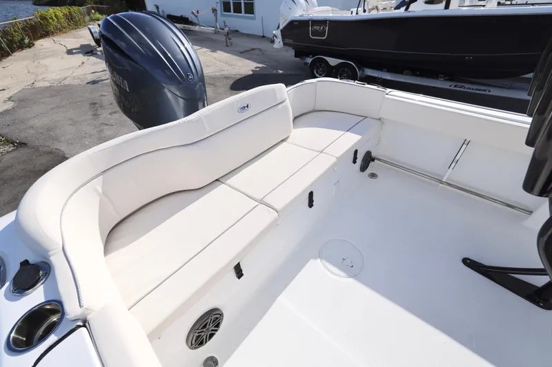 Slide: The Image of 2026 Sea Hunt Ultra 229 boat interior with white seating and Yamaha outboard motor. - 14