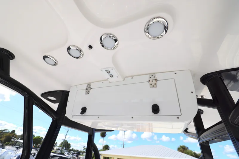Slide: The Image of 2026 Sea Hunt Ultra 229 boat interior ceiling with built-in lights and storage compartment. - 15