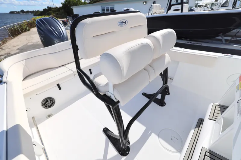 Slide: The Image of 2026 Sea Hunt Ultra 229 boat interior with white seating and black frame. - 16