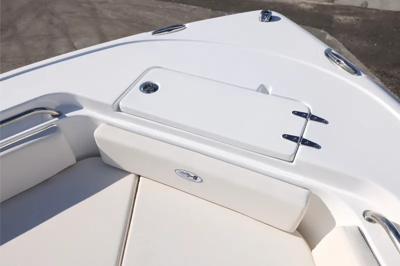 Slide: The Image of 2026 Sea Hunt Ultra 229 boat bow with white seating and storage compartment. - 19
