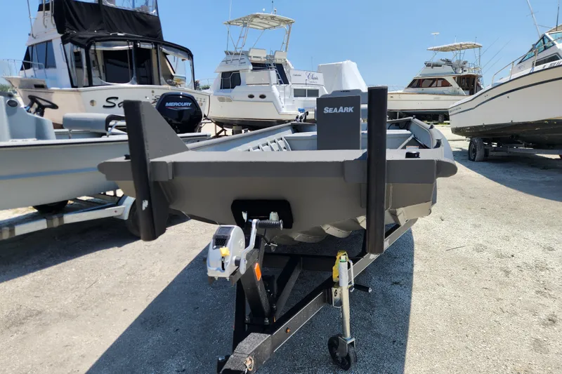 Slide: The Image of 2025 SeaArk 2072 Workhorse boat on trailer, surrounded by other boats in a marina. - 2