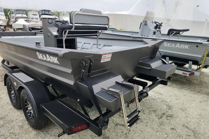 Slide: The Image of 2025 SeaArk 2072 Workhorse boat on trailer, featuring dual axles and rear ladder. - 4