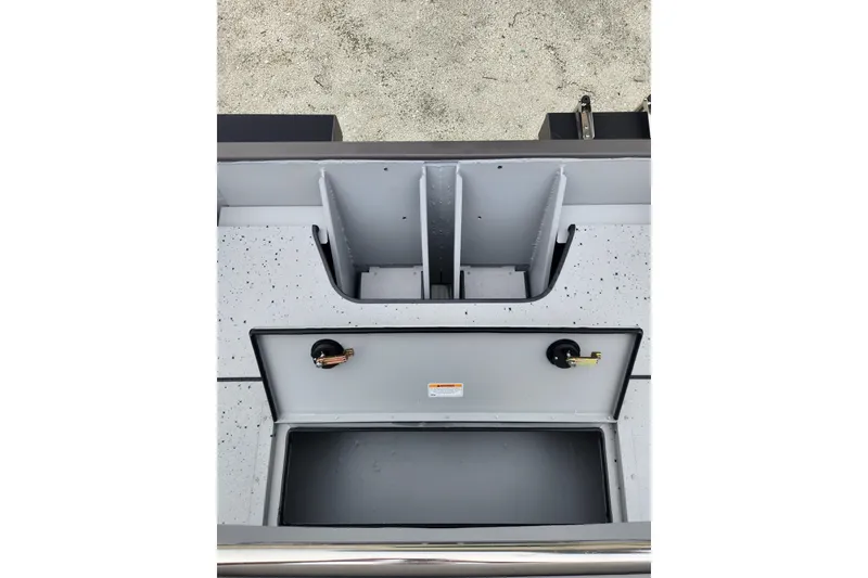 Slide: The Image of 2025 SeaArk 2072 Workhorse boat interior with storage compartments and speckled flooring. - 6