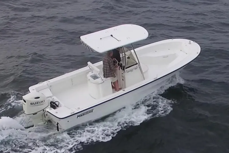 The Image of 2026 Maritime 233 Defiant boat on trailer in indoor showroom. - 0