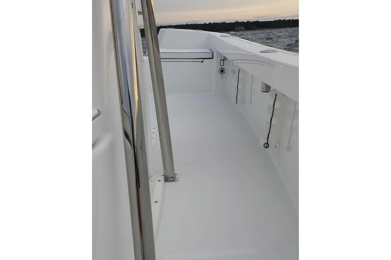 Slide: The Image of 2026 Maritime 233 Defiant boat in showroom, featuring sleek design and modern structure. - 12