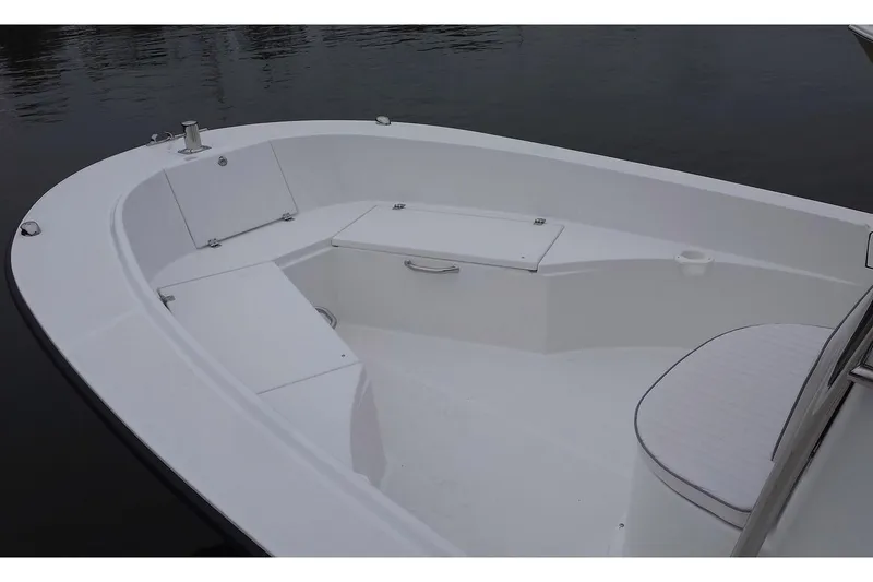 Slide: The Image of 2026 Maritime 233 Defiant boat with Yamaha outboard motor in a garage setting. - 2