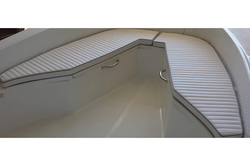 Slide: The Image of 2026 Maritime 233 Defiant boat in a garage, featuring a powerful outboard motor. - 3