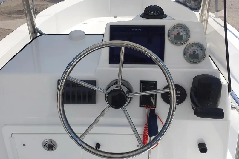 Slide: The Image of 2026 Maritime 233 Defiant boat with Yamaha engine in a workshop setting. - 4