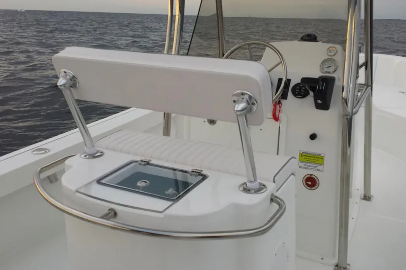 Slide: The Image of 2026 Maritime 233 Defiant boat interior with Yamaha outboard motor in showroom. - 5