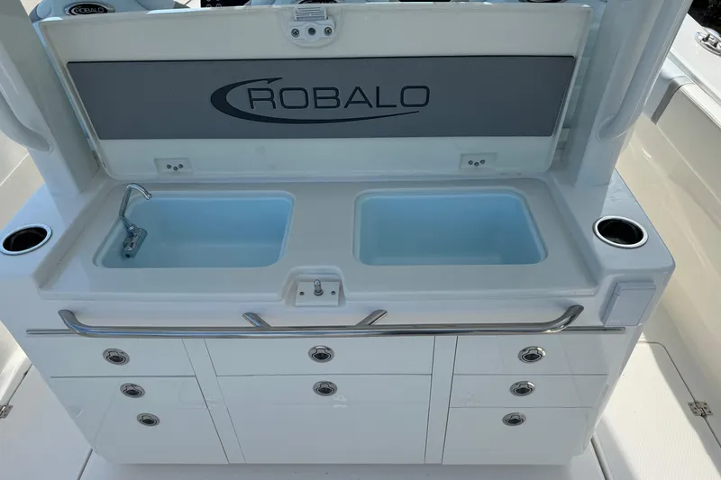 Slide: The Image of 2025 Robalo R360 Center Console boat sink and storage area. - 15
