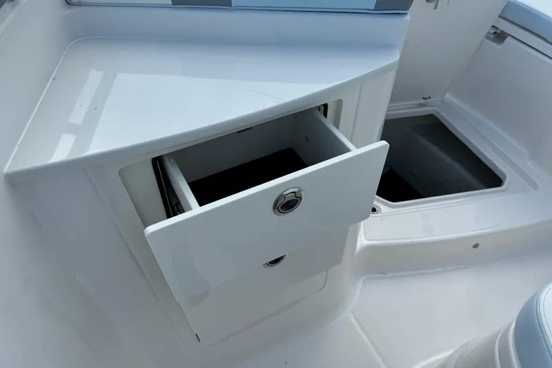 Slide: The Image of 2025 Robalo R360 Center Console boat with open storage compartment. - 28