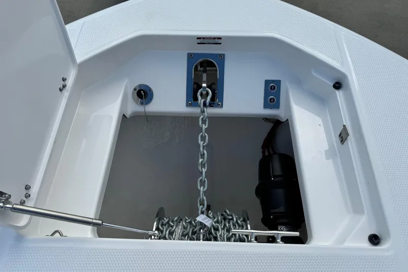 Slide: The Image of 2025 Robalo R360 Center Console anchor locker with chain and winch system. - 35