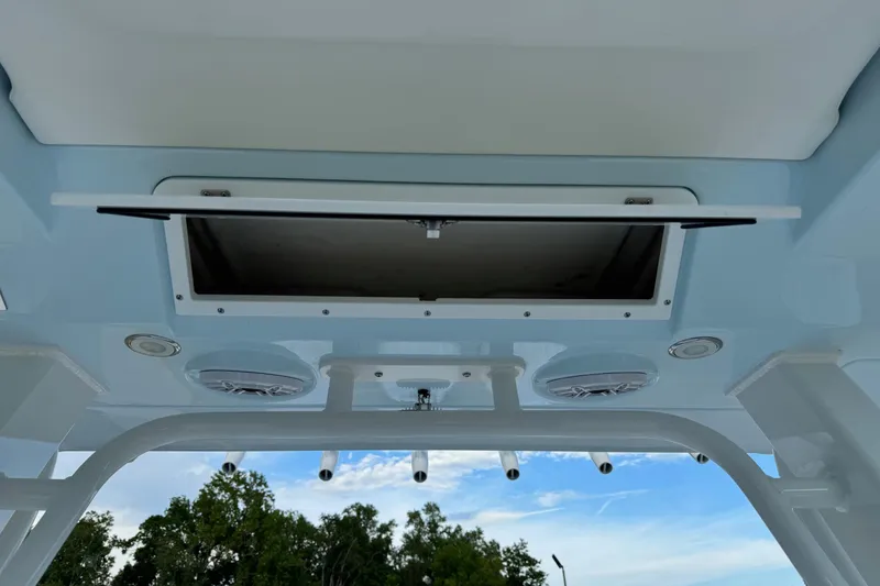 Slide: The Image of 2025 Robalo R360 Center Console boat ceiling with open hatch and speakers. - 37