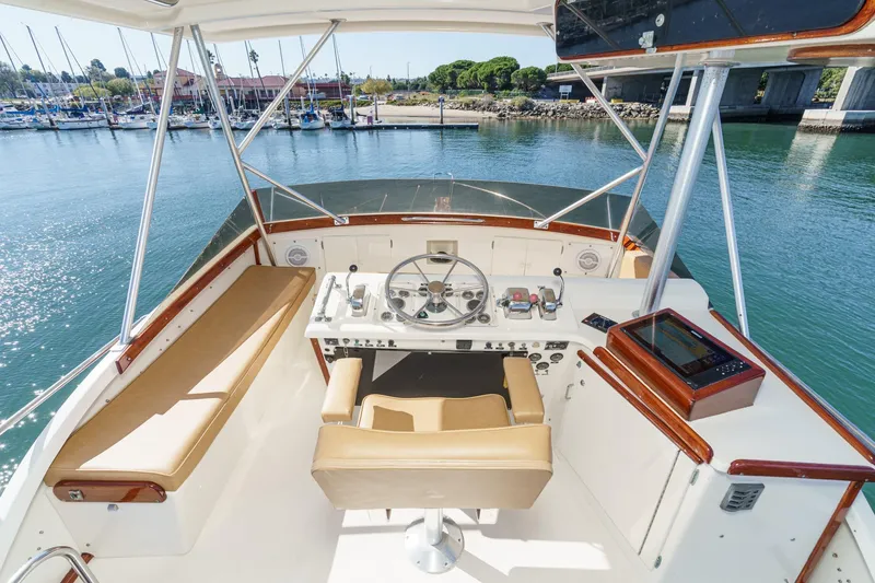 Slide: The Image of Helm of 1984 Post 43 yacht with steering wheel, controls, and navigation equipment. - 22