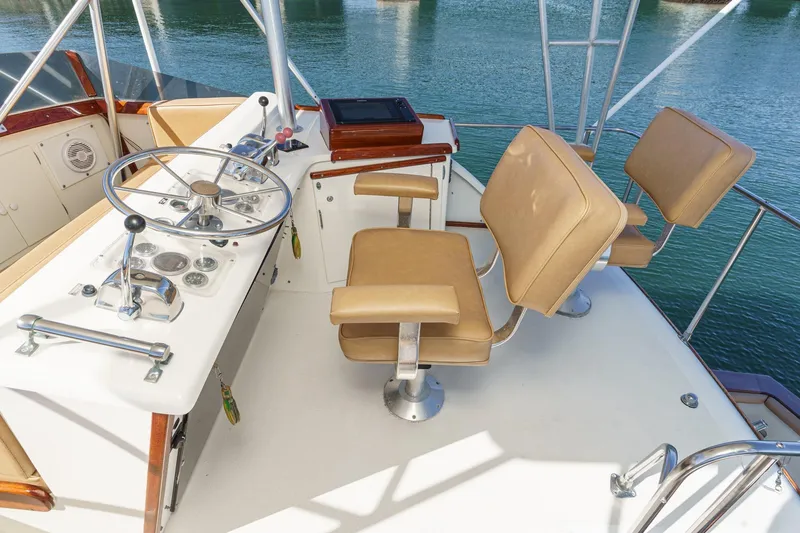 Slide: The Image of Helm of 1984 Post 43 yacht with tan seats and steering wheel. - 23