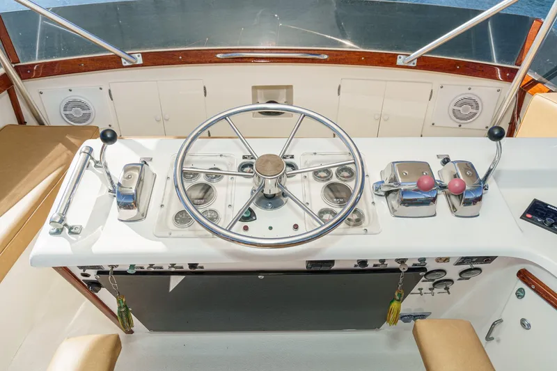 Slide: The Image of 1984 Post 43 yacht helm with steering wheel, controls, and gauges. - 24