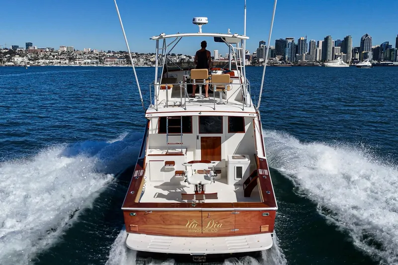 Slide: The Image of Vintage 1984 Post 43 yacht cruising with city skyline in the background. - 28