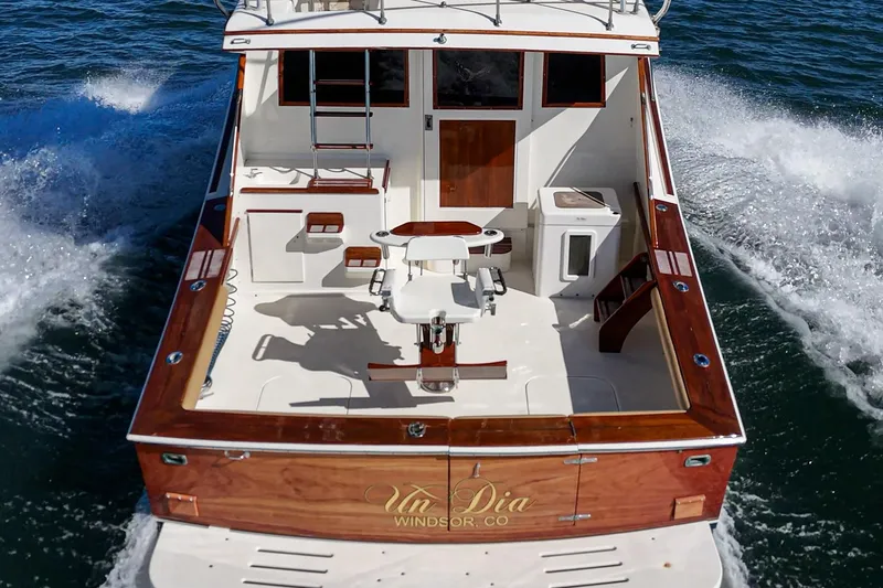 Slide: The Image of 1984 Post 43 boat cruising on water, featuring a spacious deck and elegant wood finishes. - 31